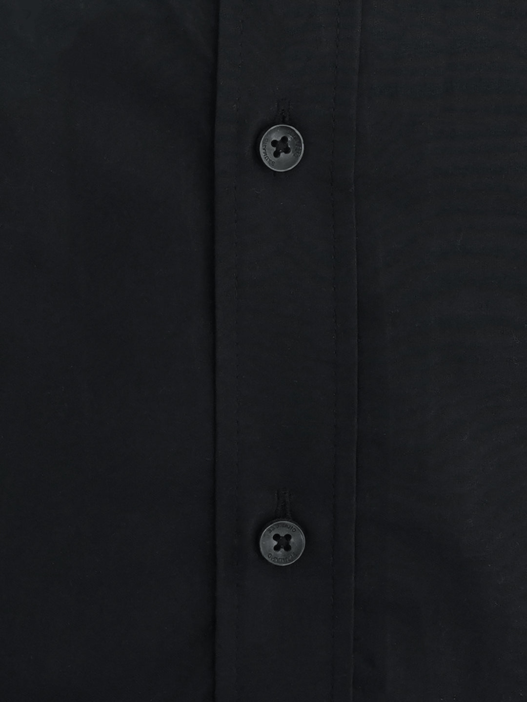 Close up of yellow ribbon accent on black cotton shirt