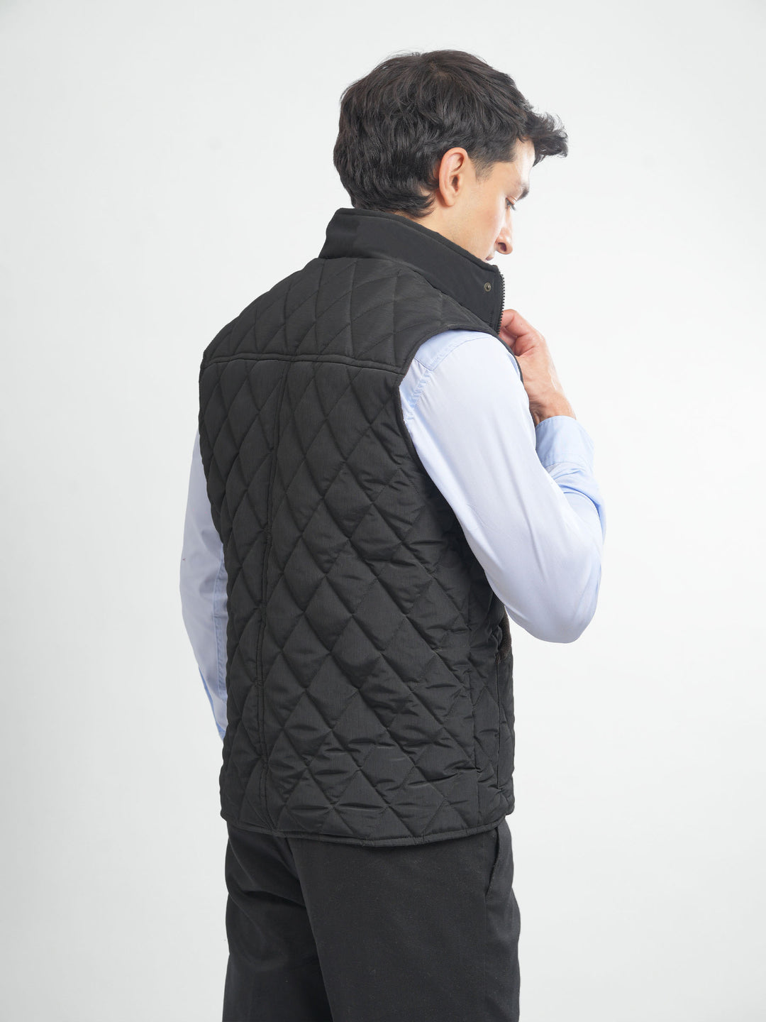 Back view of black sleeveless puffer jacket
