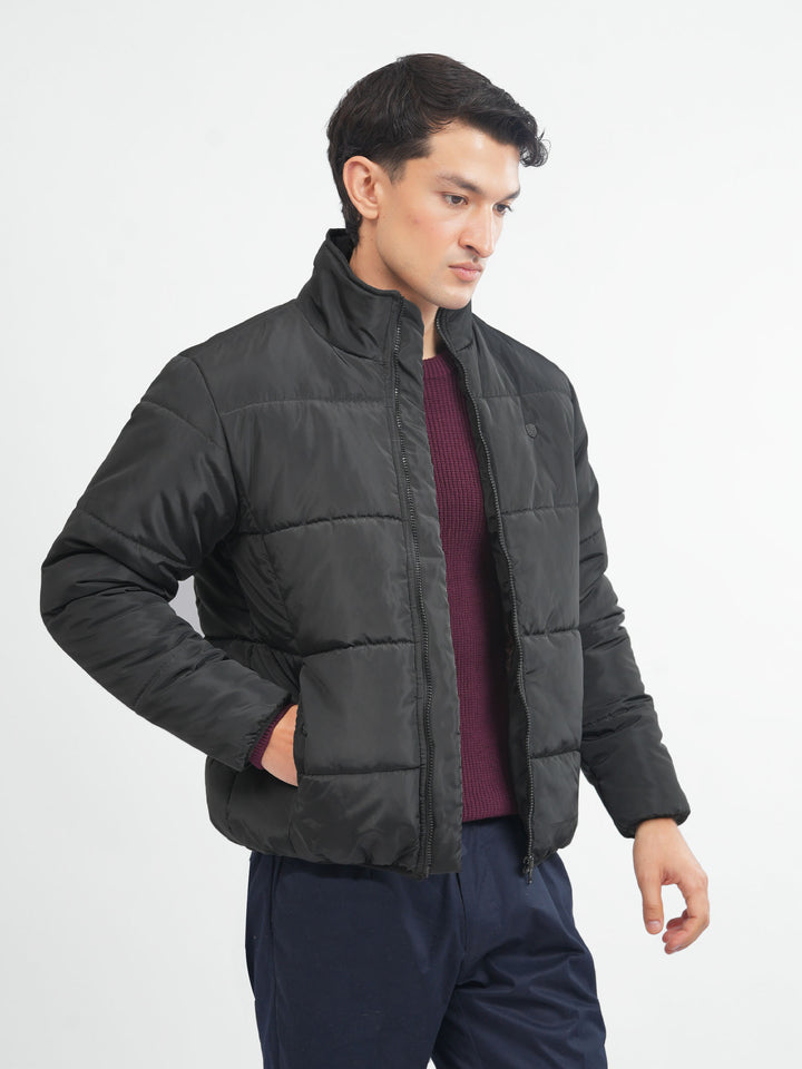 Men's black quilted puffer jacket front view
