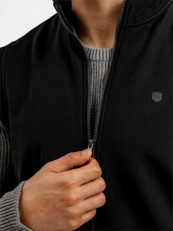 Close up of zipper detail on black sleeveless jacket