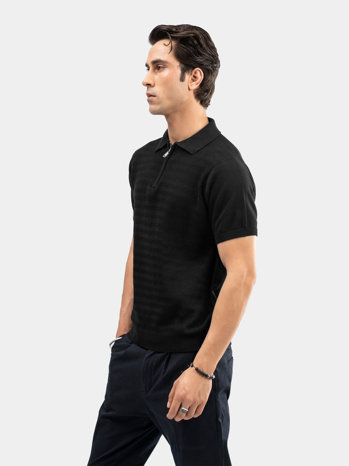 Man wearing black flat knit zipper polo shirt