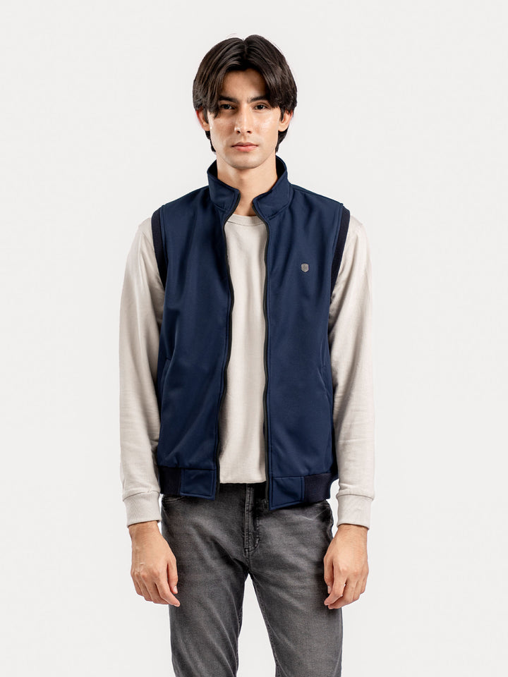 Model wearing blue sleeveless jacket in Pakistan