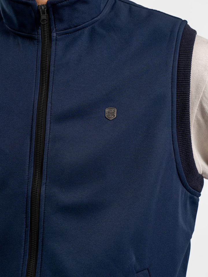 Close up of zipper detail on blue sleeveless jacket