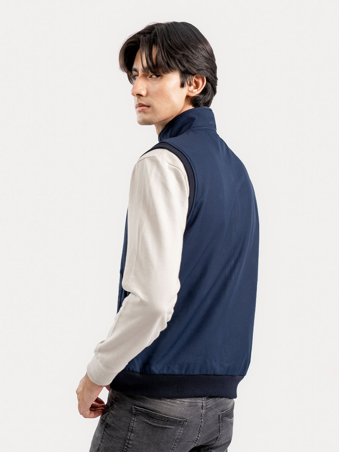 Back view of men's blue sleeveless outerwear