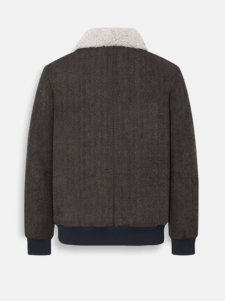 Back view of brown herringbone jacket showing ribbed hem and cuffs