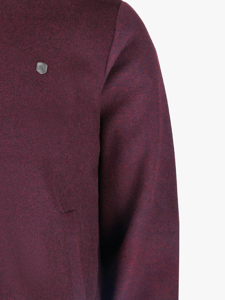 Texture detail of felted wool blend fabric in burgundy