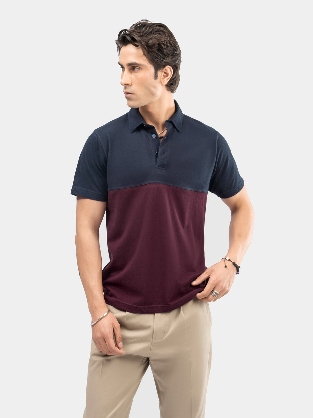 Man wearing burgundy and navy polo shirt