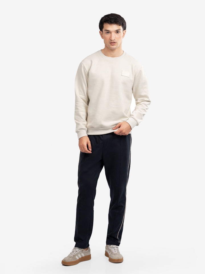 Model wearing cream crew neck pullover for winter