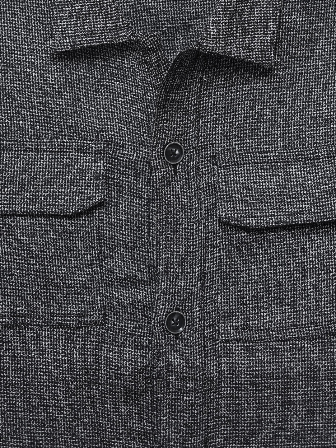 Close up of front flap pockets on grey overshirt