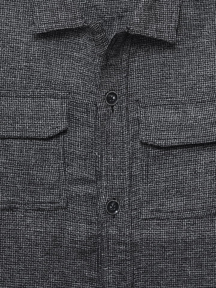 Close up of front flap pockets on grey overshirt