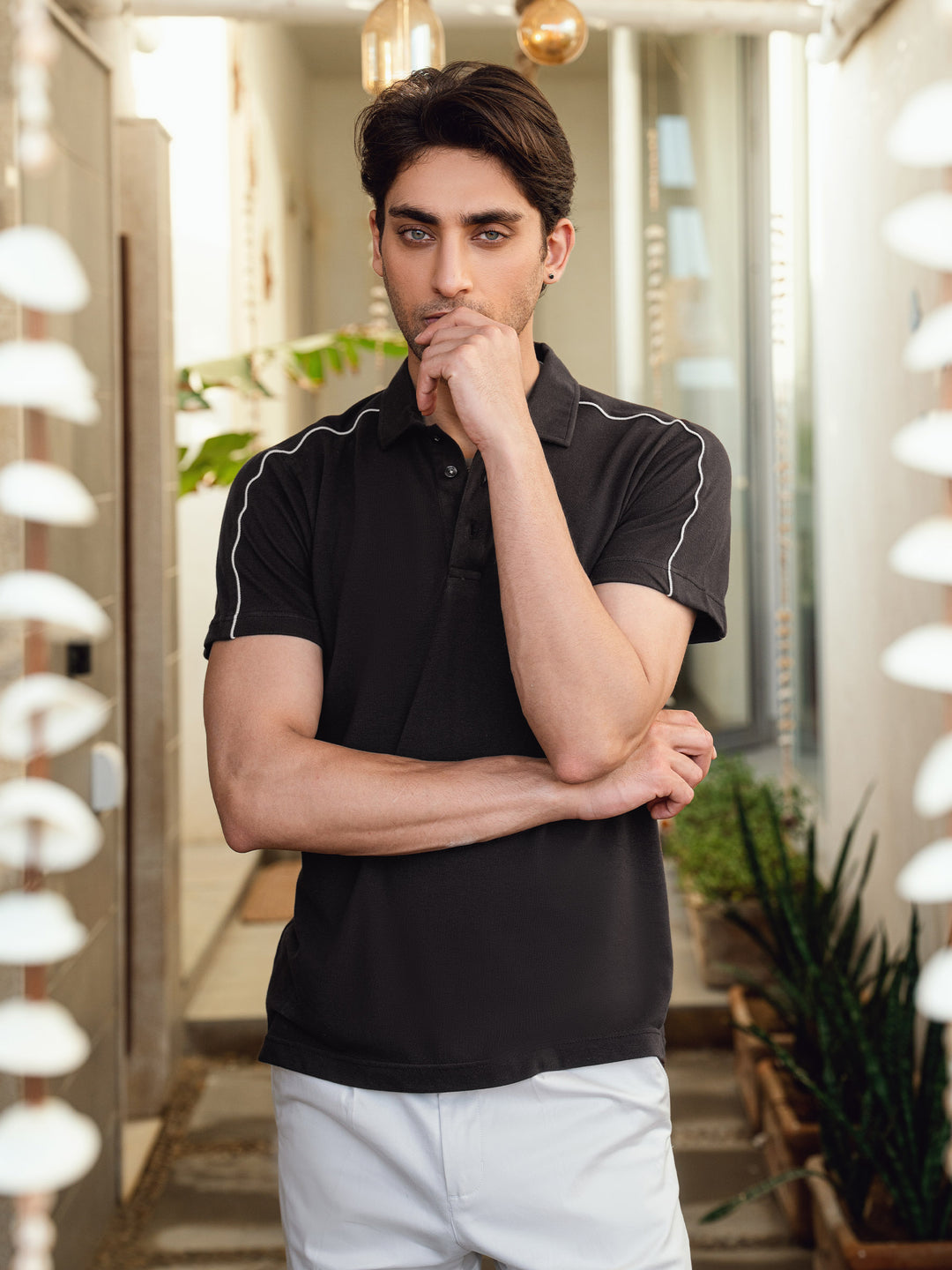 Button placket and collar detail of dark brown polo