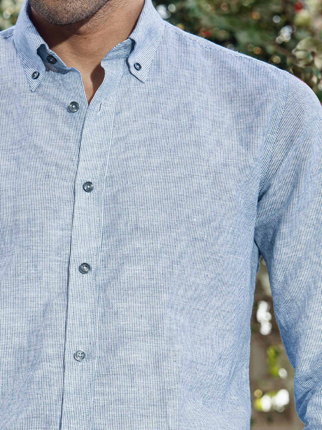 Close up of breathable linen fabric and button down collar on grey shirt