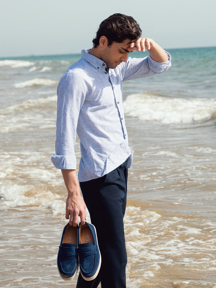 Man wearing casual grey striped linen shirt outdoors