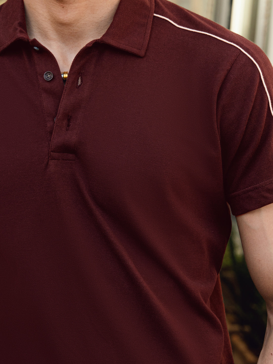 ose-up of pique cotton fabric on maroon polo