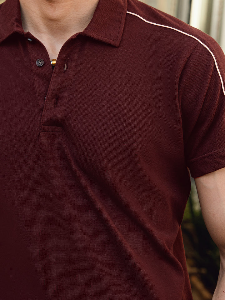 ose-up of pique cotton fabric on maroon polo