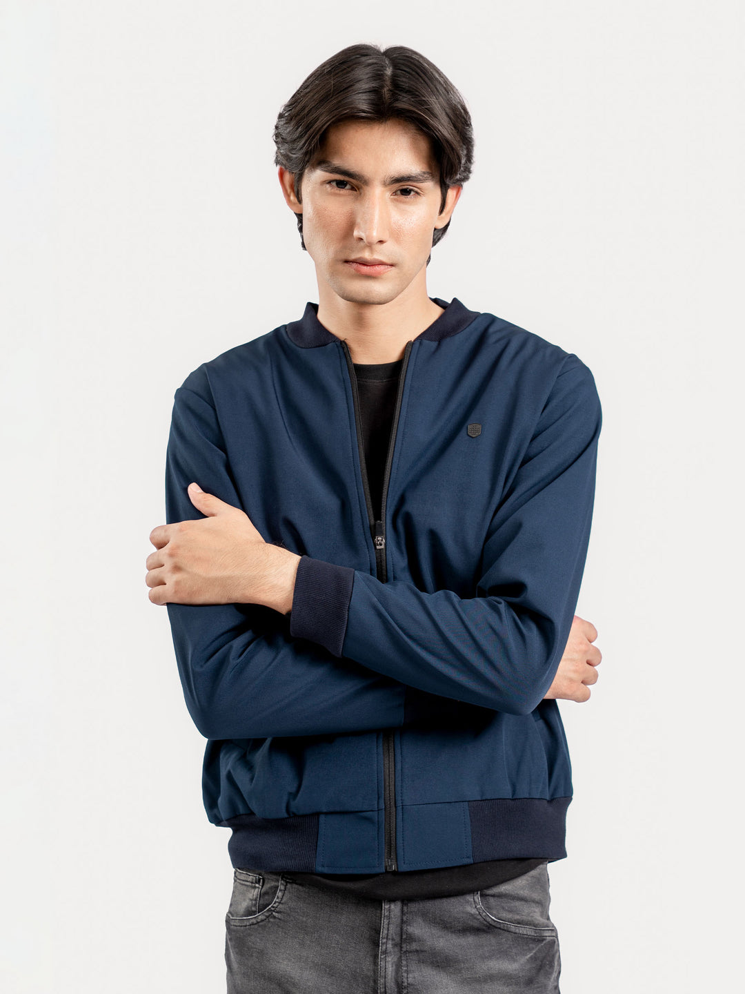 Model wearing navy bomber jacket with jeans
