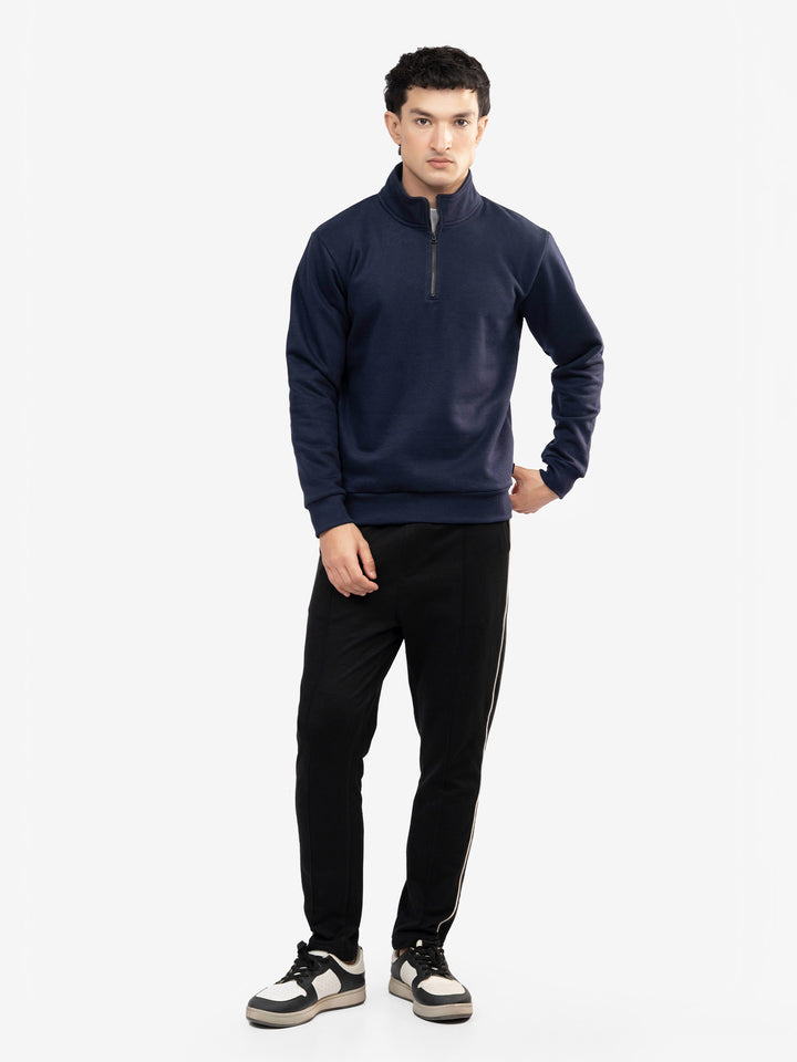 Model wearing navy blue mock neck sweatshirt in Pakistan