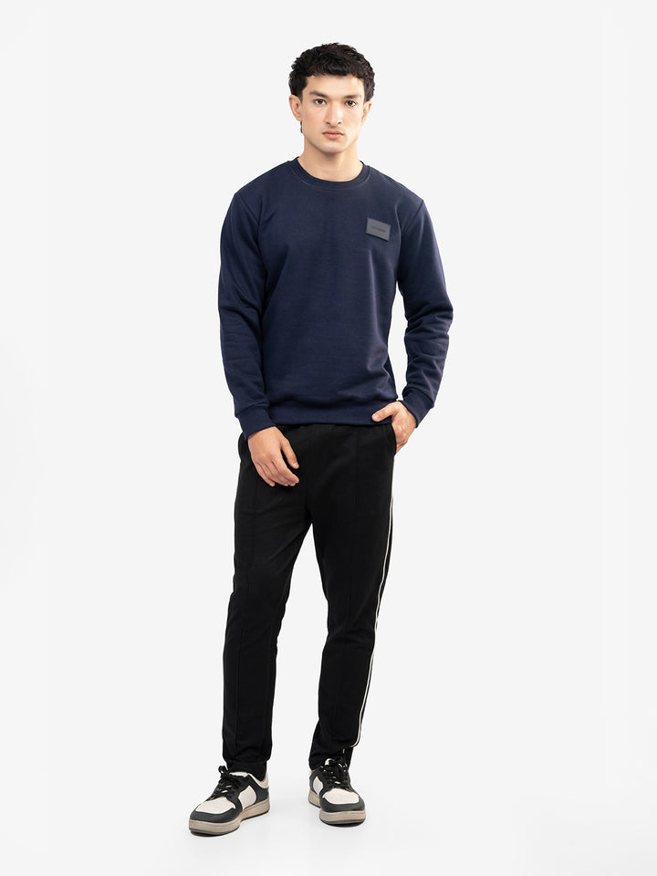 Model wearing navy blue winter sweatshirt in Pakistan