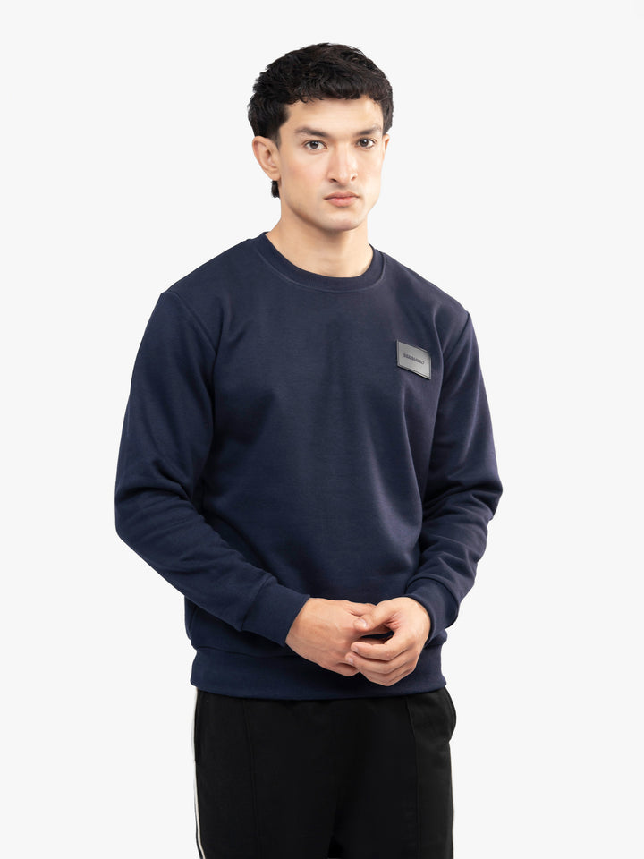 Model wearing navy blue winter sweatshirt in Pakistan