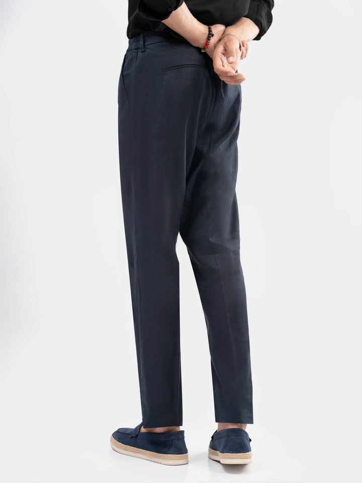 Back pocket detail of men navy blue trousers