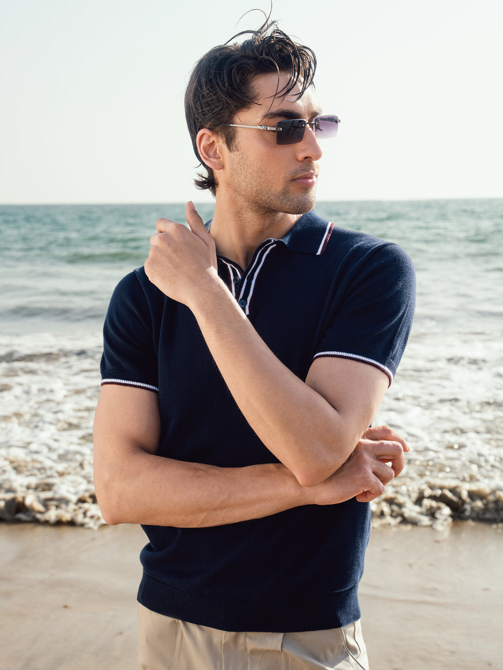 Man wearing navy blue short sleeve polo shirt outdoors