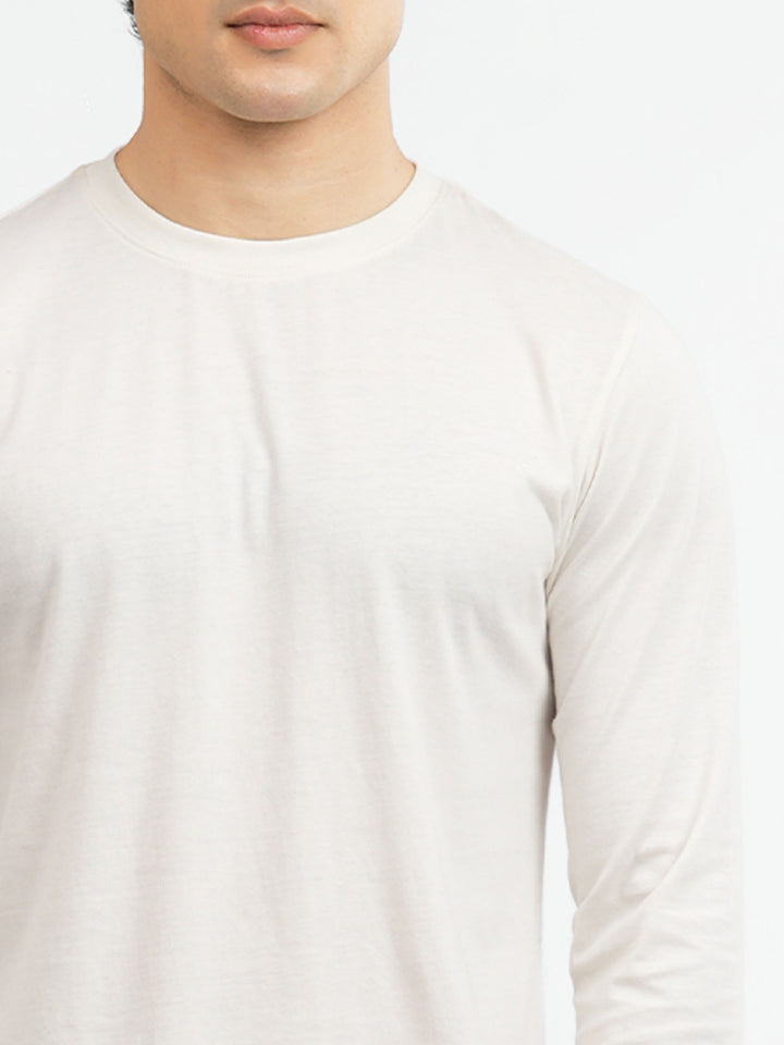 Close-up of crew neckline on vanilla long sleeve t-shirt