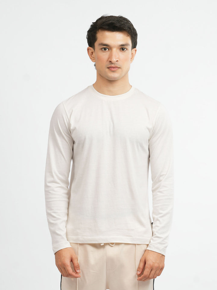 Model wearing vanilla t-shirt with beige trousers for casual look