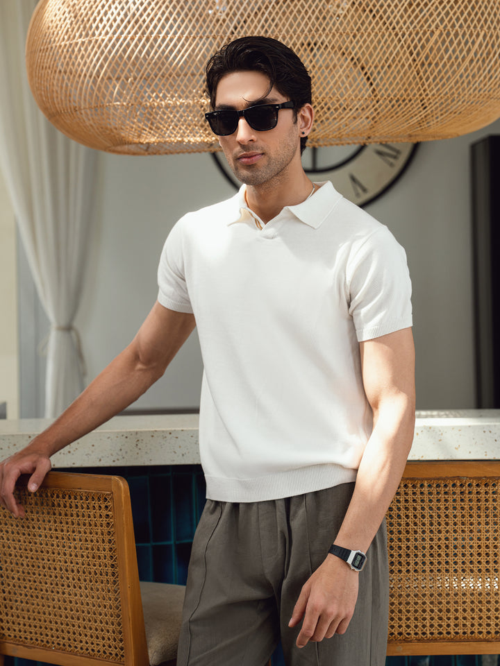Man wearing vanilla polo shirt with casual trousers